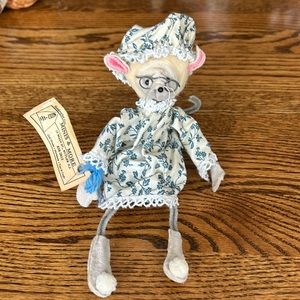 Handcrafted pipe cleaner mouse in dress and bonnet.